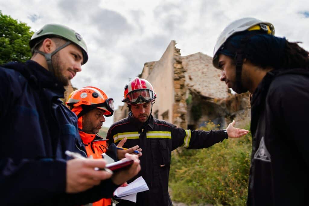 2 men in blue and orange jacket wearing helmet