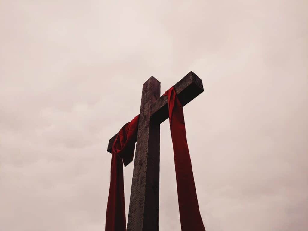 low angle view of cross with red garment