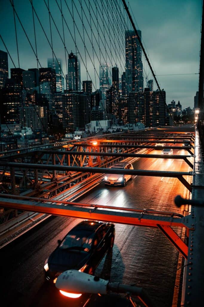 cars on road near city buildings during night time