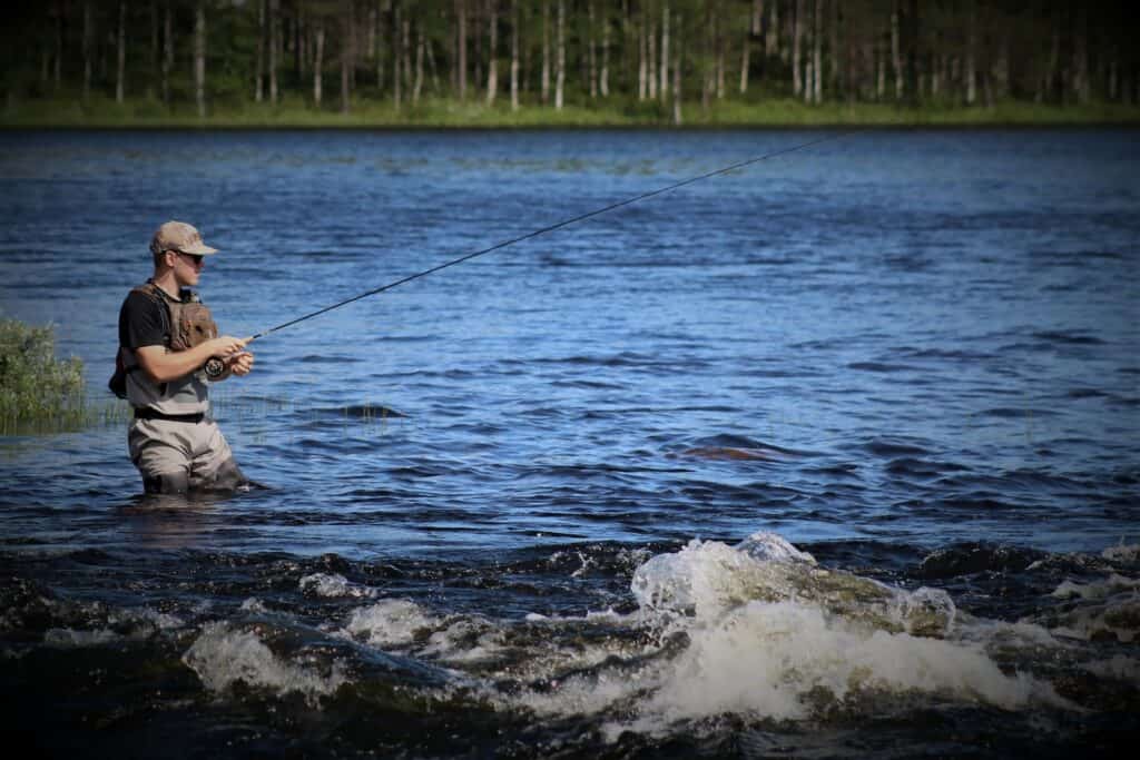 person fishing on river during daytime